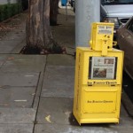 Newspaper machine on the curb