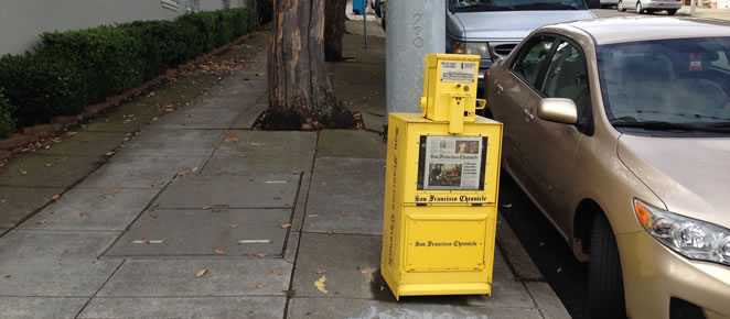Newspaper machine on the curb