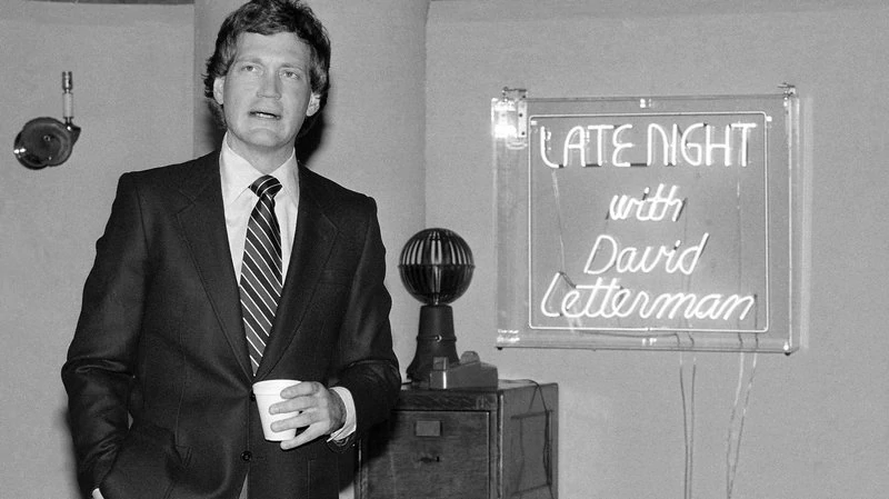 Letterman holding a cup of coffee