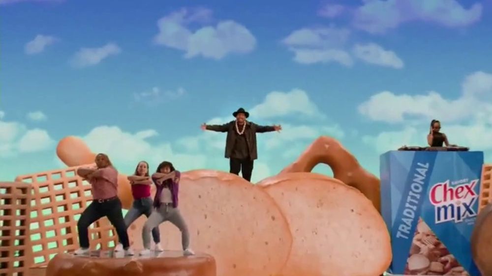 Sir Mix-a-Lot standing on top of an impossibly large bagel chip.