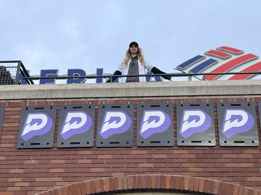 The Daughter standing above the Oracle Park arcade seating wall