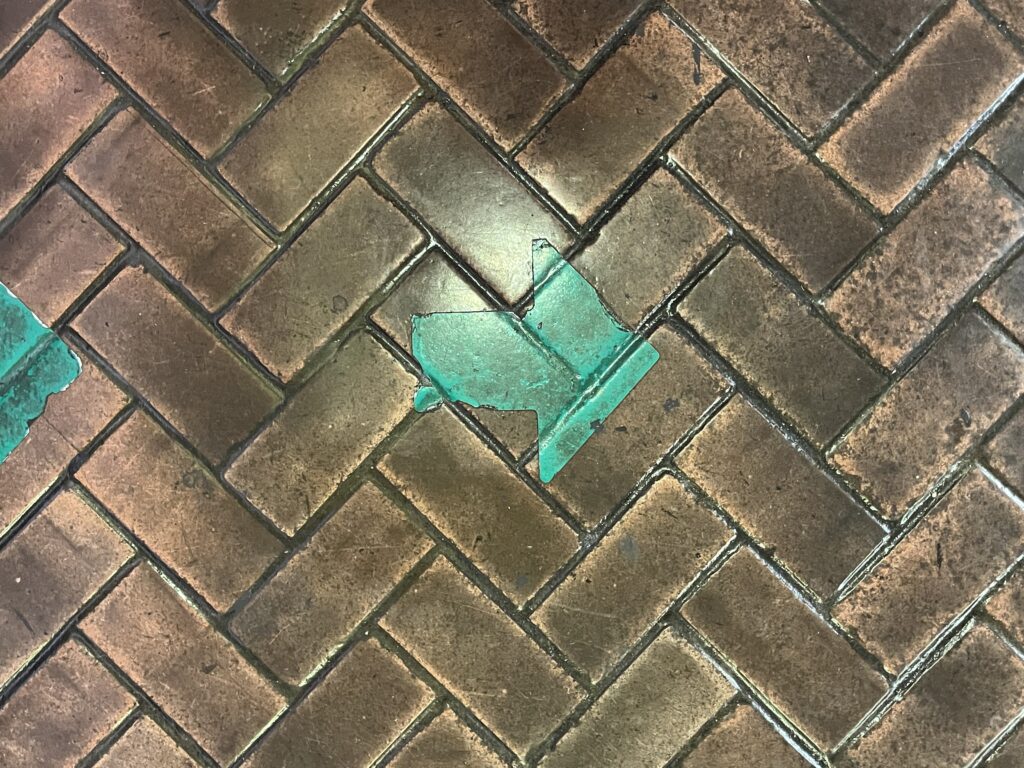 Green arrow painted on bricks