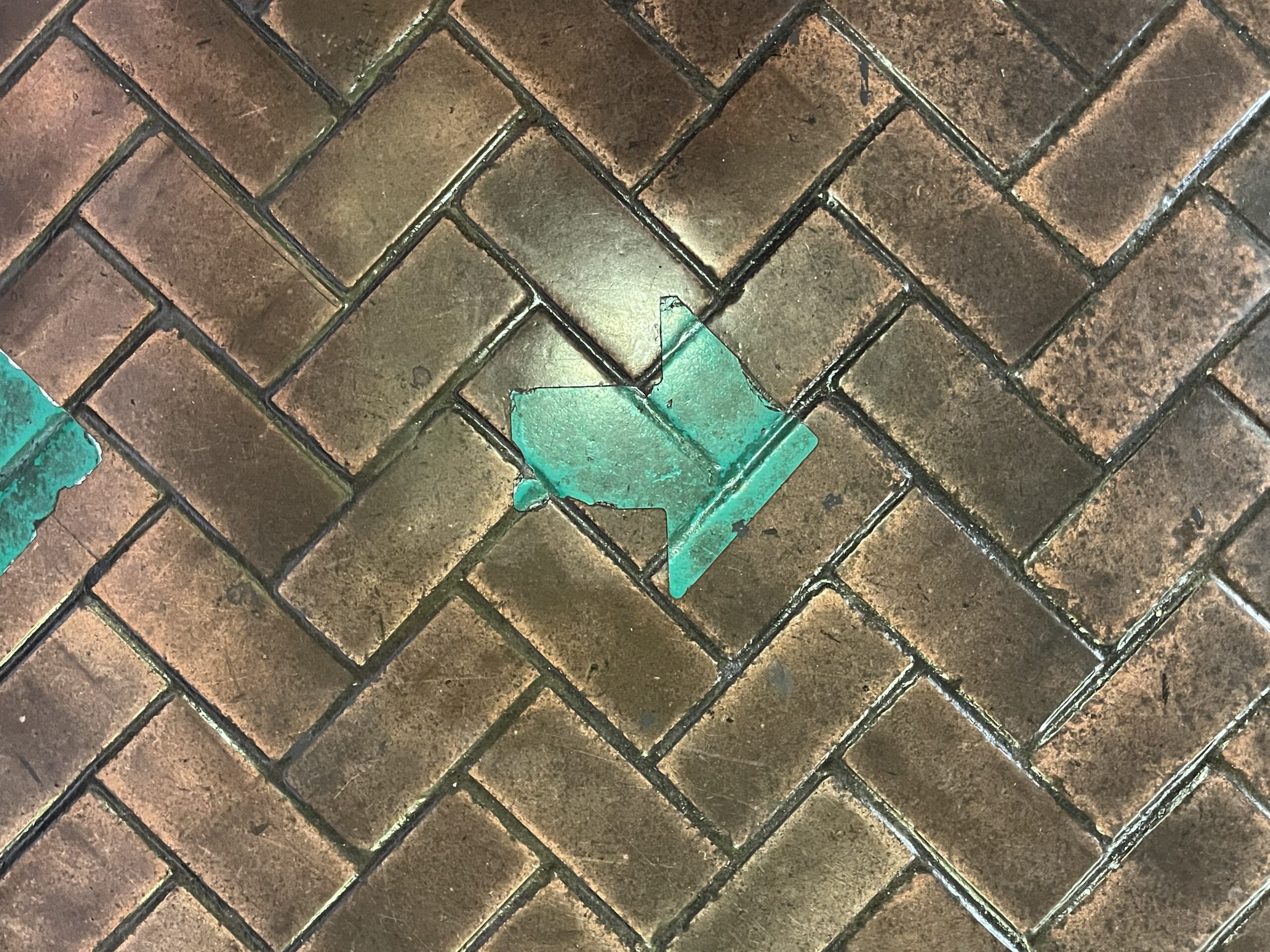 Green arrow painted on bricks