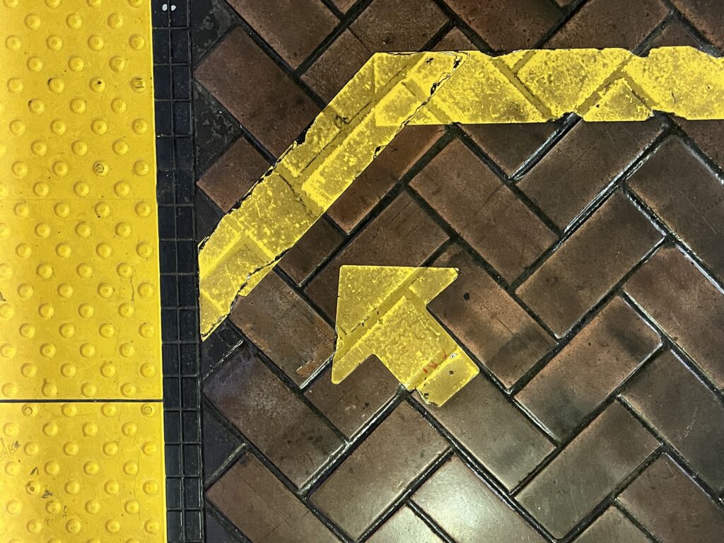 Yellow arrow painted on bricks