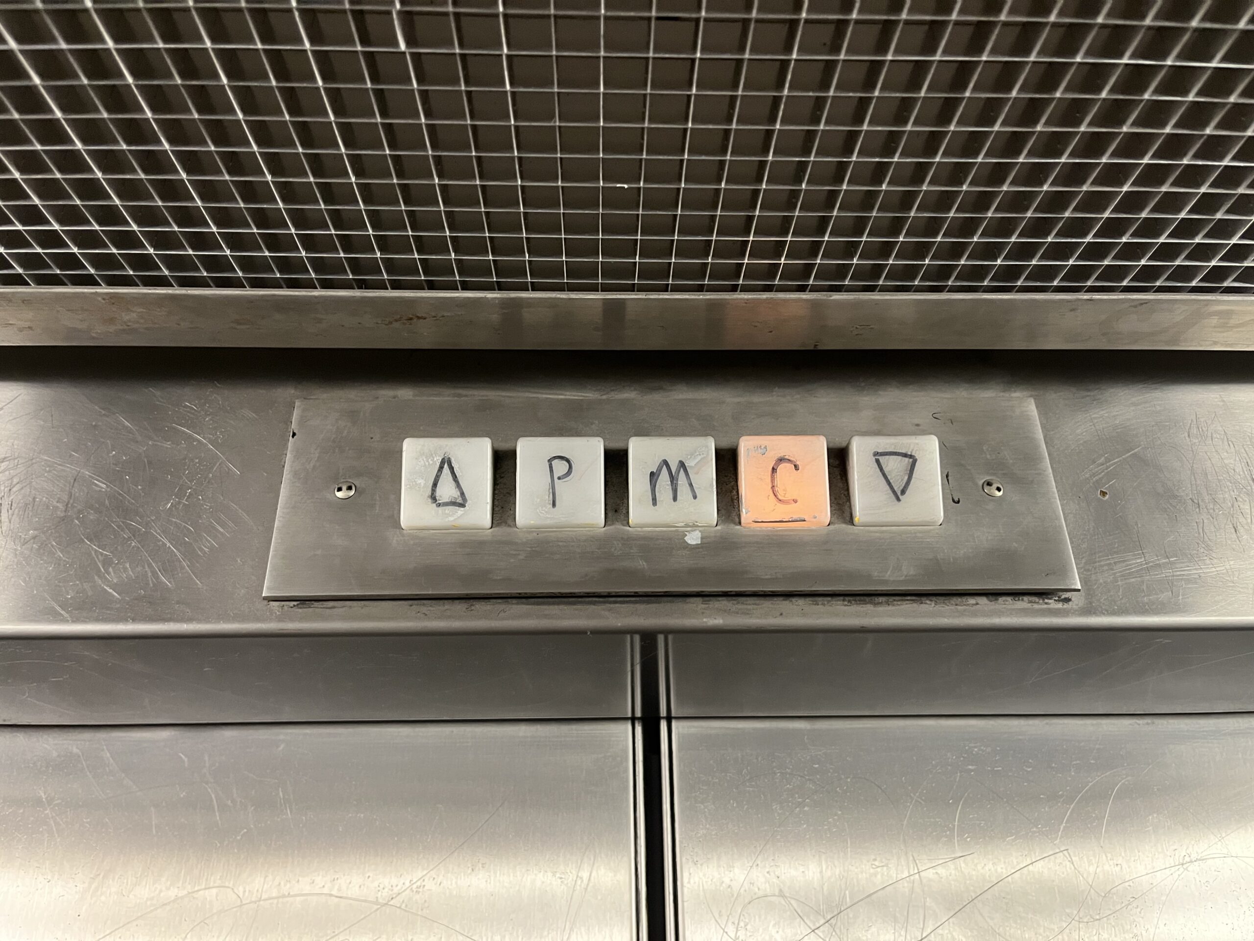 Hand-drawn arrows in an elevator