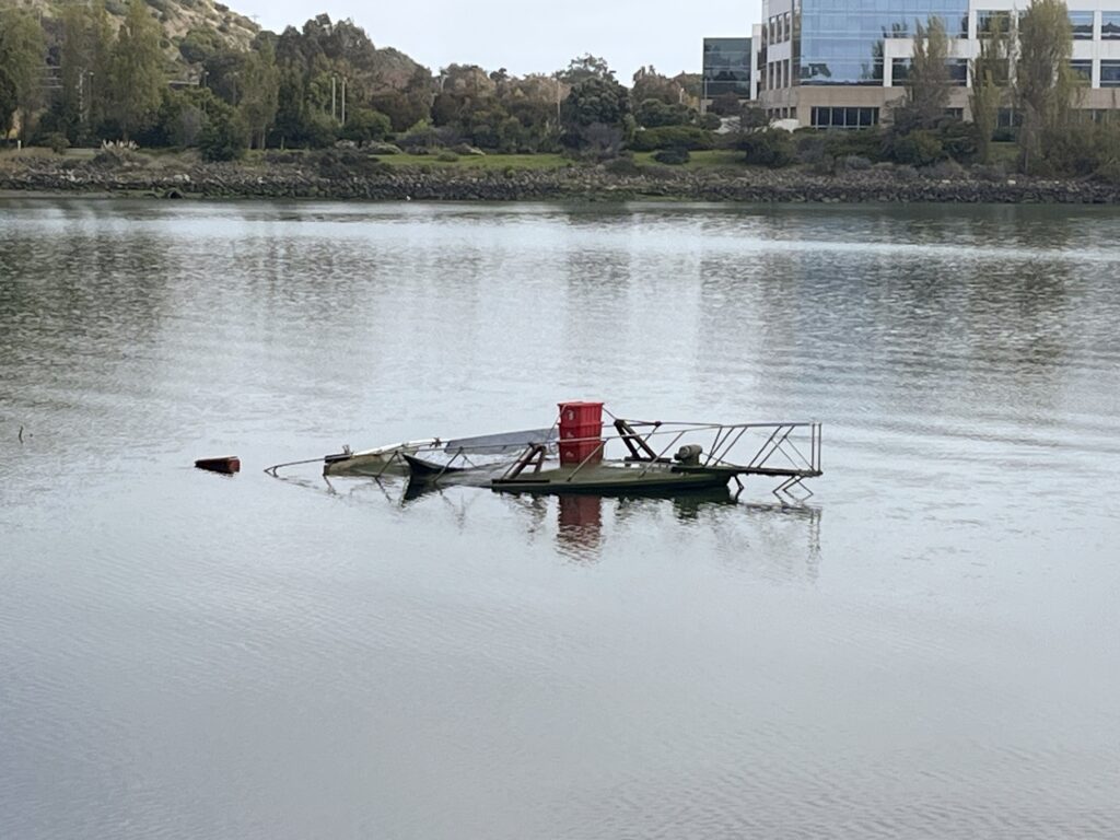 The top of a mostly submerged boat